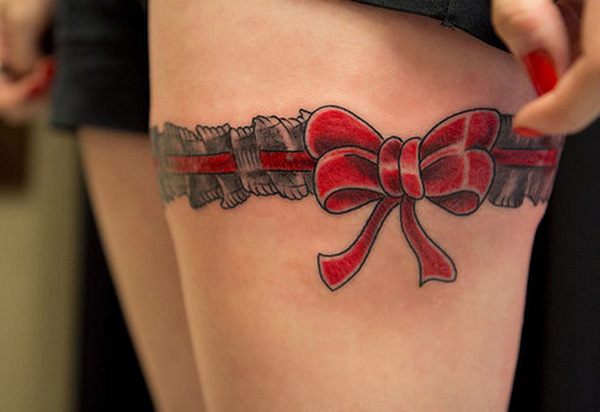 Bow tattoos on back of thighs