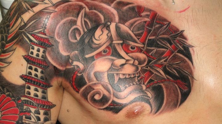 grey-ink-oni-mask-tattoo-on-chest-2