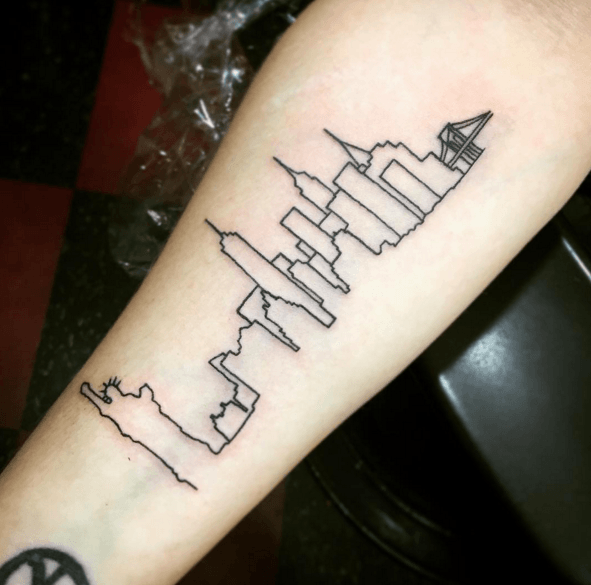 Fine line New York City skyline tattoo on the bicep