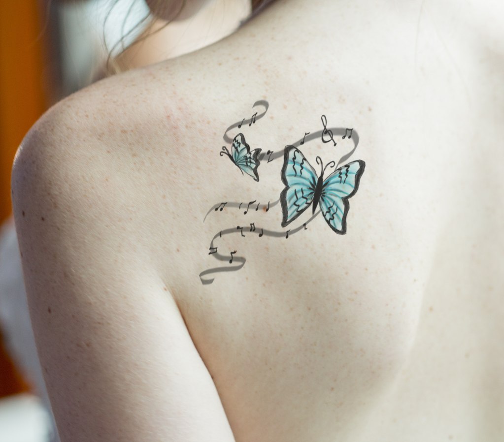 Unique Colorful Butterfly Tattoo Desings With Treble Clef On Back