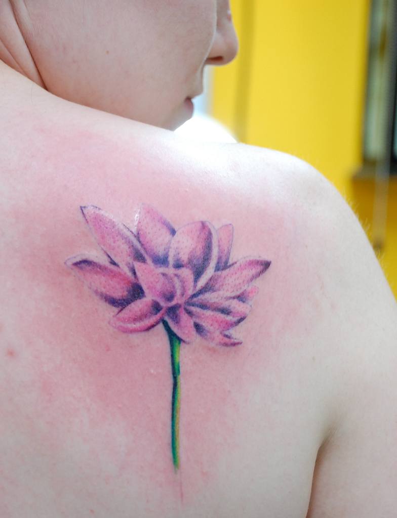 Lotus Tattoo On Back Of A Woman