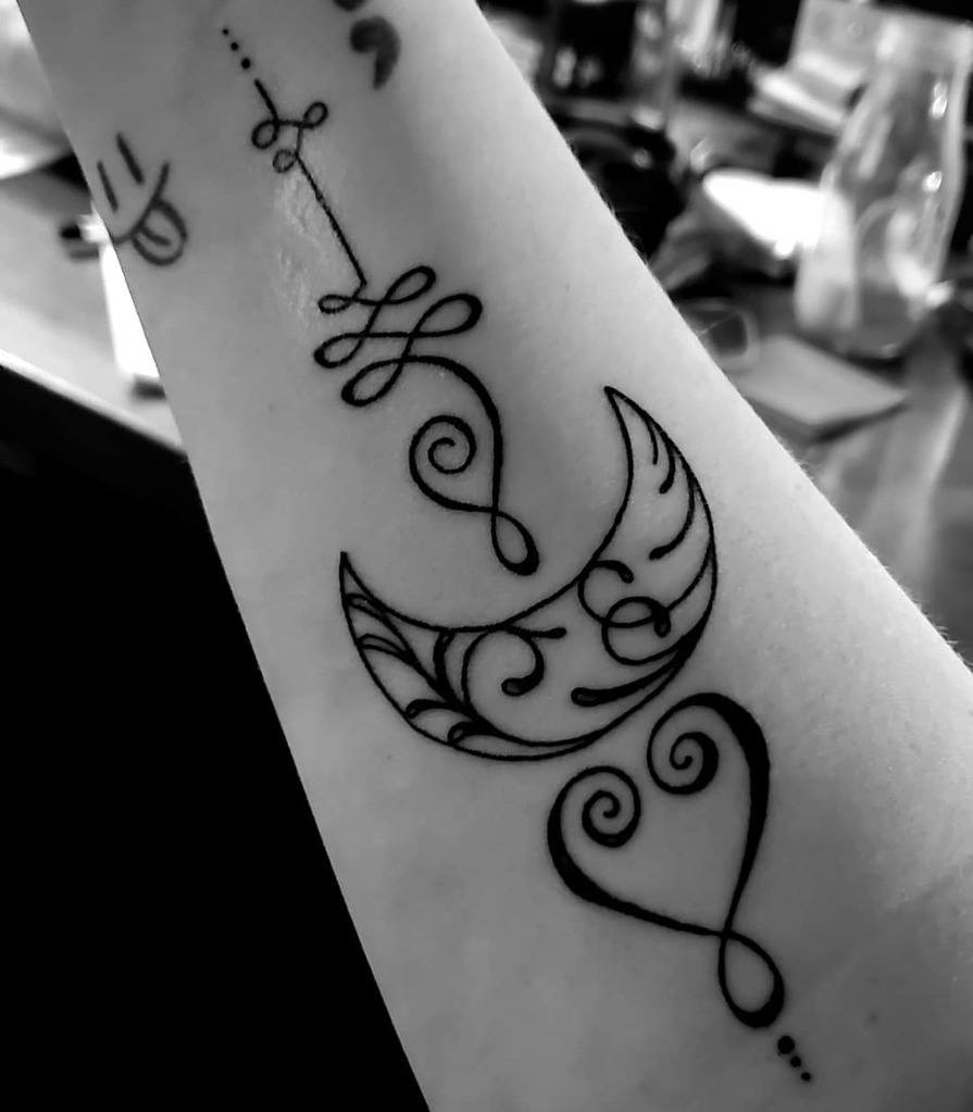 Unalome with crescent moon tattoo on hand.