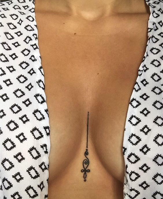 Unalome tattoo between breast.