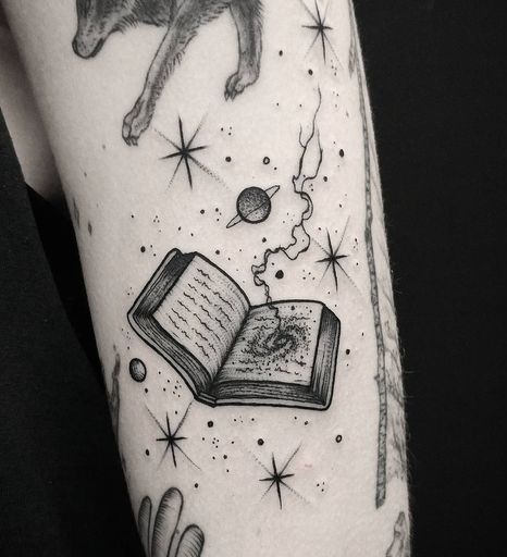 Open Book With Stars, Planet and Cyclone Tattoo.