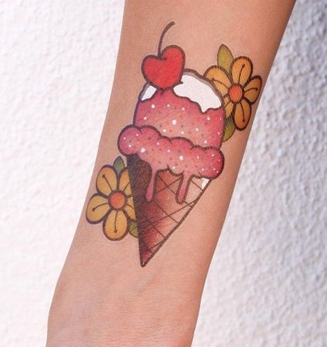 Ice Cream with flower and apple tattoo on hand
