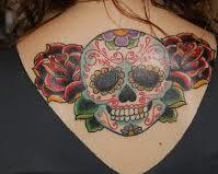Rose And Skull Tattoo On Back Of A Woman