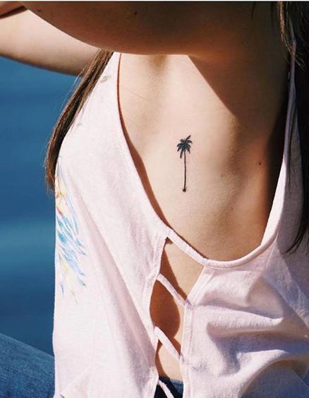 Palm Tree Tattoo On Side Of A Woman.