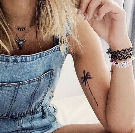Palm Tree Tattoo On Hand Of A Girl.