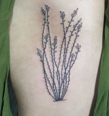 Plant Tattoo On Thigh Of A Woman