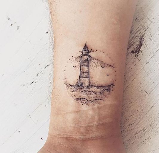 Lighthouse tattoo on wrist for parents.