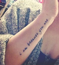 "I am because you are" Quote tattoo on hand of a woman.