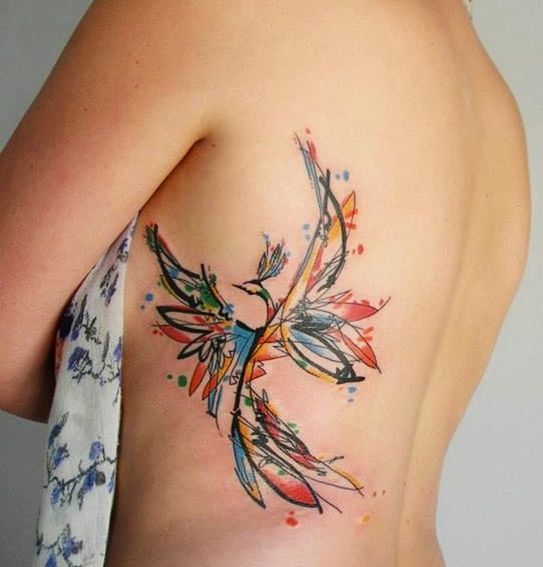 Colorful Phoenix Tattoo on side of a girl.