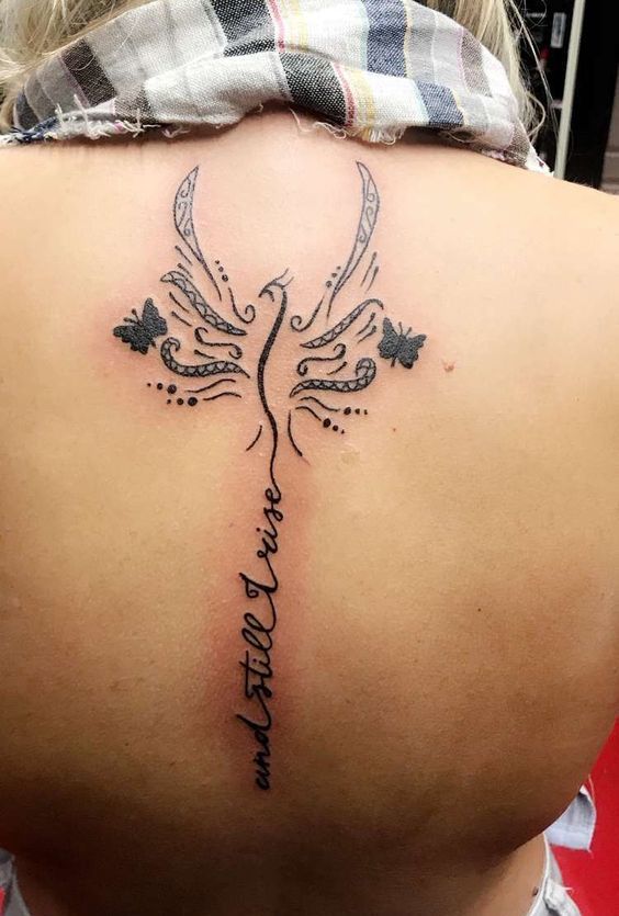 Phoenix Tattoo & 'And Still I Rise' written on back for woman.