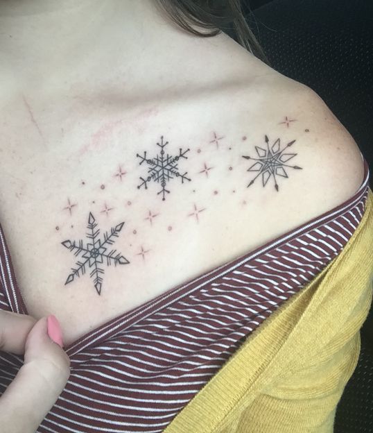 Snowflake Tattoo on shoulder of a woman.