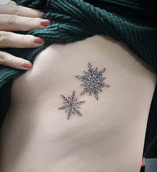 Snowflake Tattoo on side of a girl.
