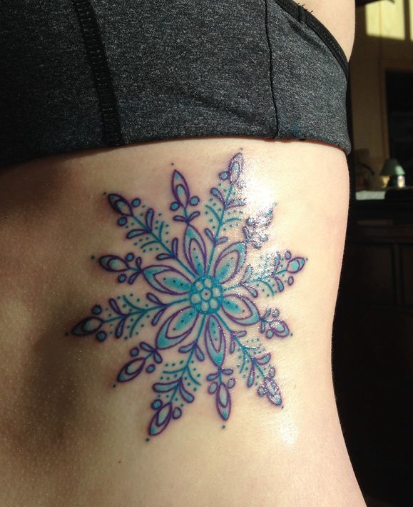 Purple & Blue Snowflake Tattoo on side of a girl.