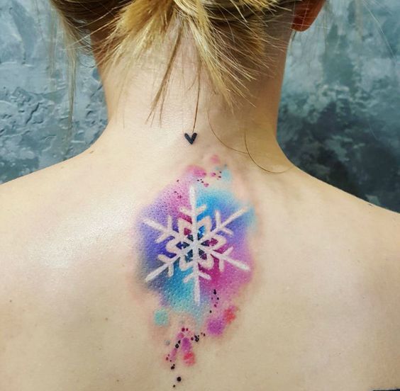 Snowflake Tattoo on back with water color negative effect.