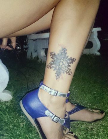 Snowflake Tattoo on leg of a woman.