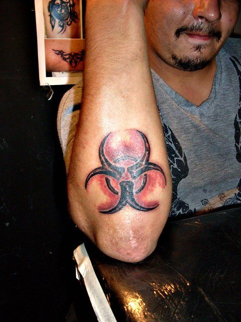 Biohazard  Red Black Color Tattoo on forearm