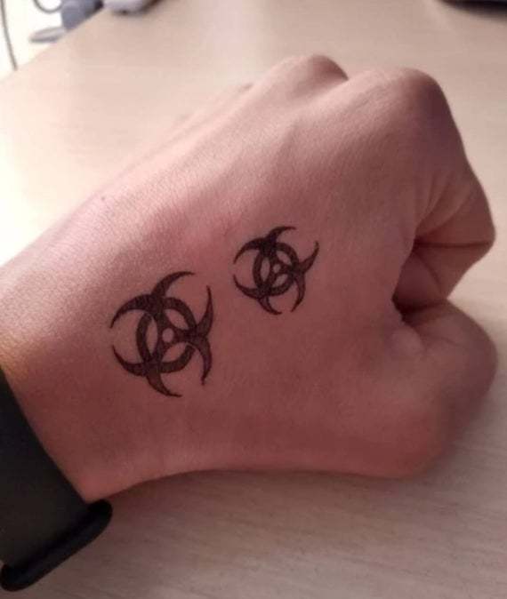 Small Biohazard Tattoo on Hand for Men