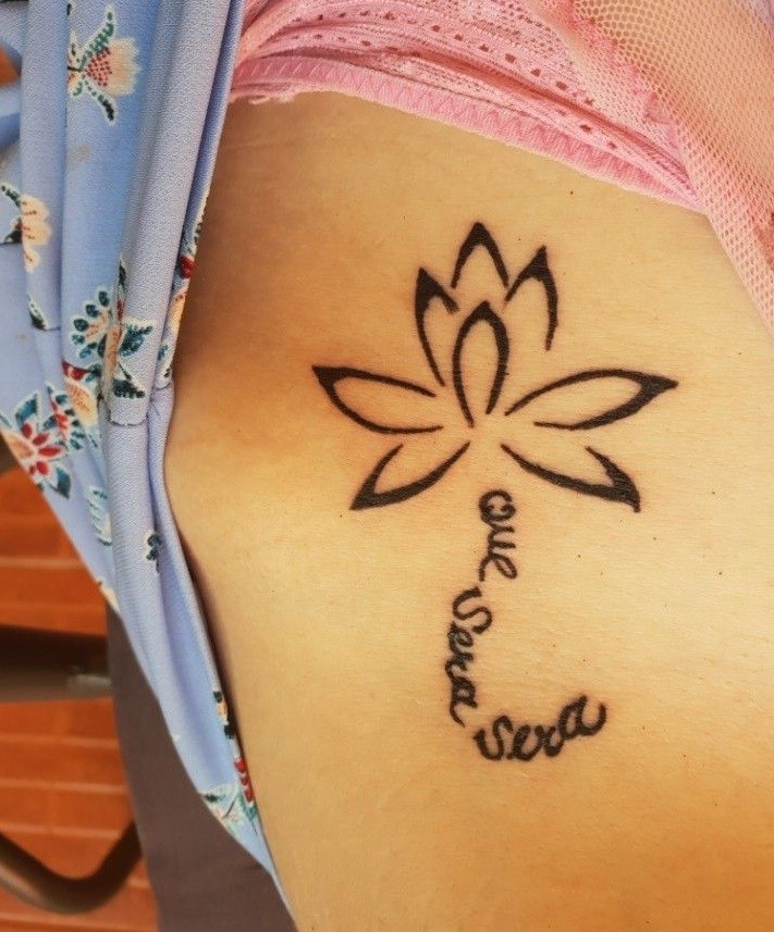 Que sera sera tattoo with lotus flower 