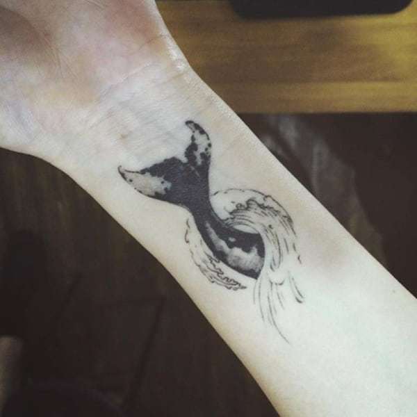 Wave Tattoo with whale style on wrist 