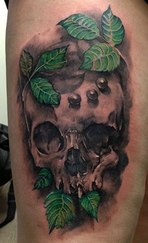 skull with green leaves tattoo
