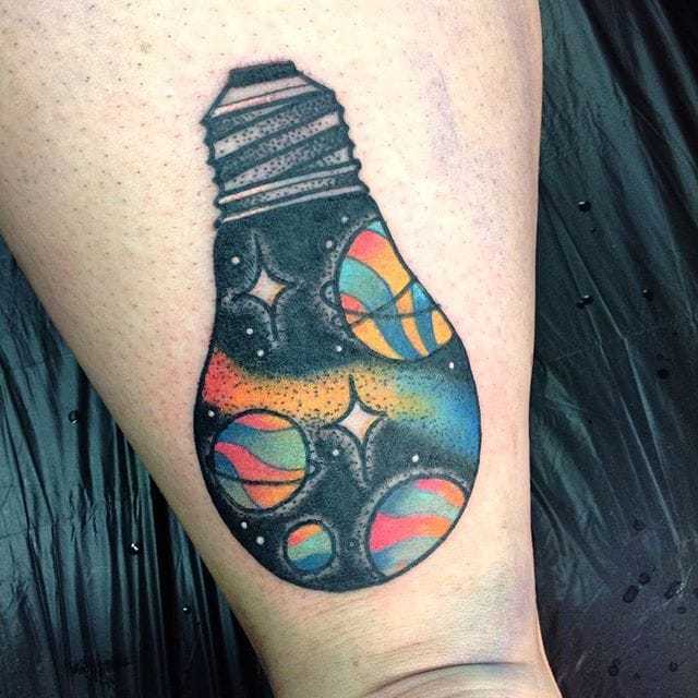 Light Bulb Tattoo with solar system on leg.