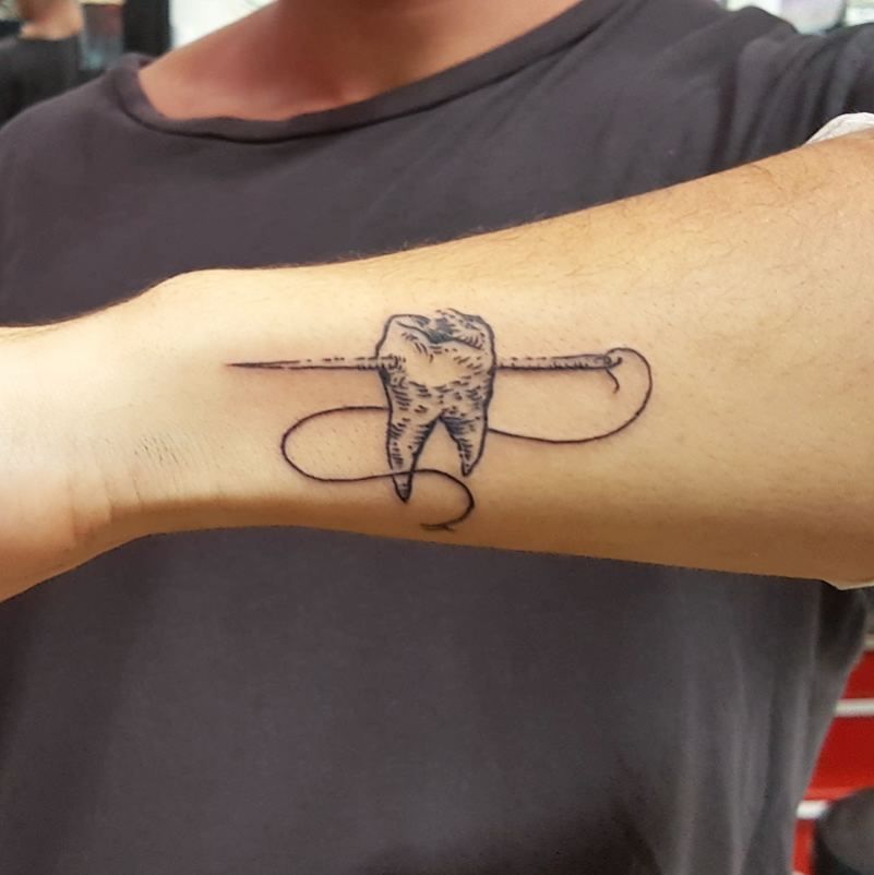 The Meaning Behind Tooth Tattoo - TattoosWin