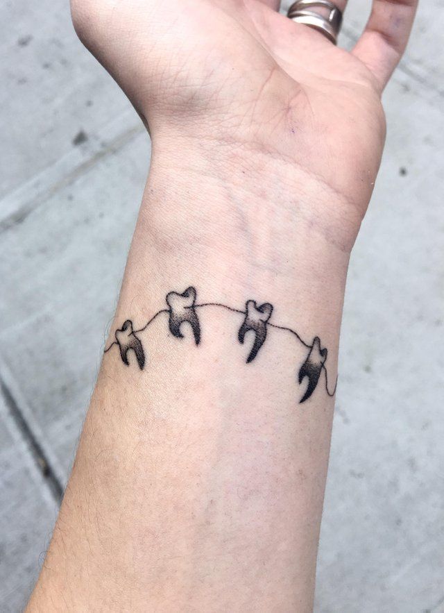 Tooth Tattoo with Thread on hand