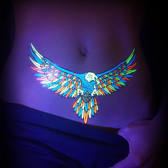 Bird UV Light Tattoo on stomach for women 
