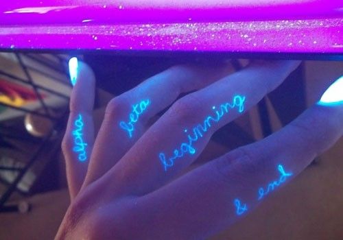 Script Based UV Light Tattoo on fingers