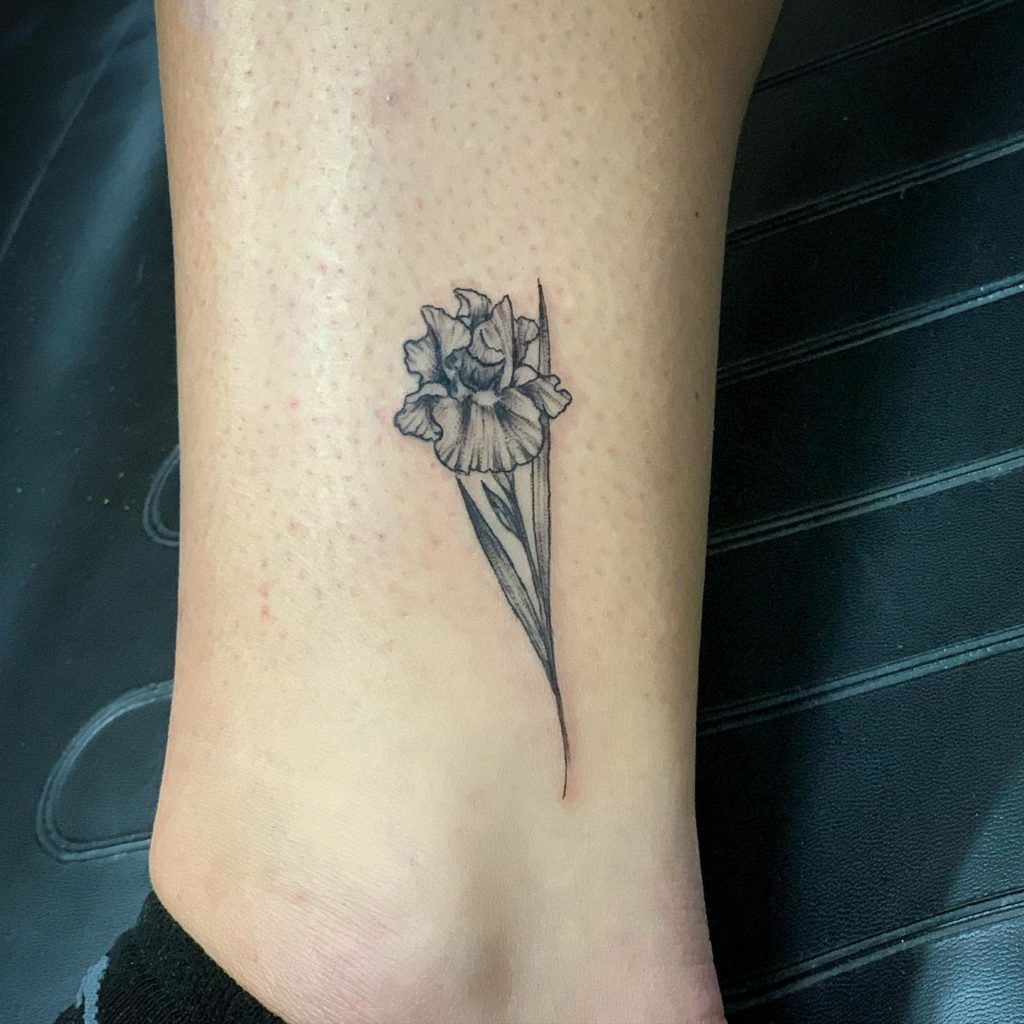 Black Iris flower tattoo on leg for women