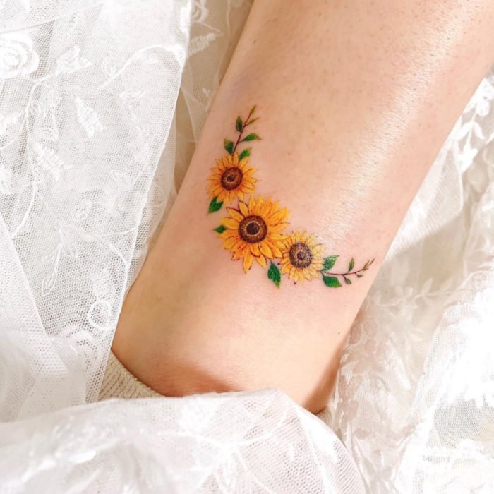 Small Sunflower tattoo with tiny green leafs 