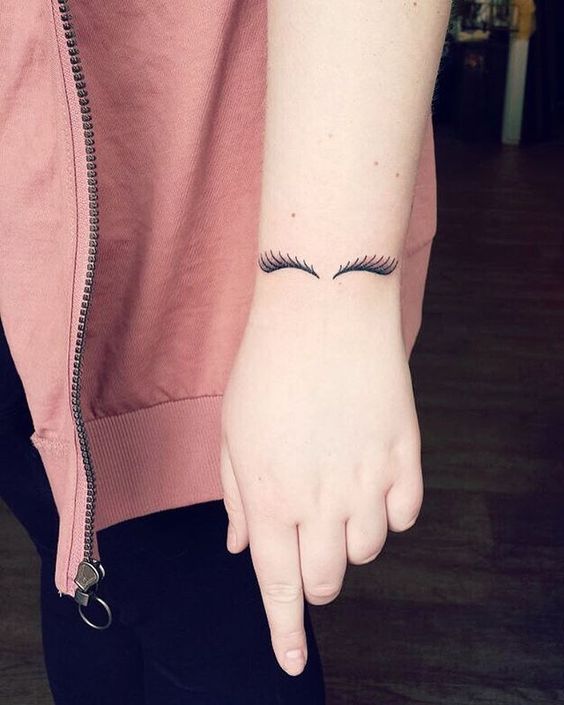 Beautiful eyelash tattoo on hand for women